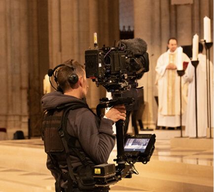 Camera operator filming in a cathedral