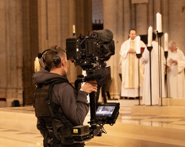 Camera operator filming in a cathedral